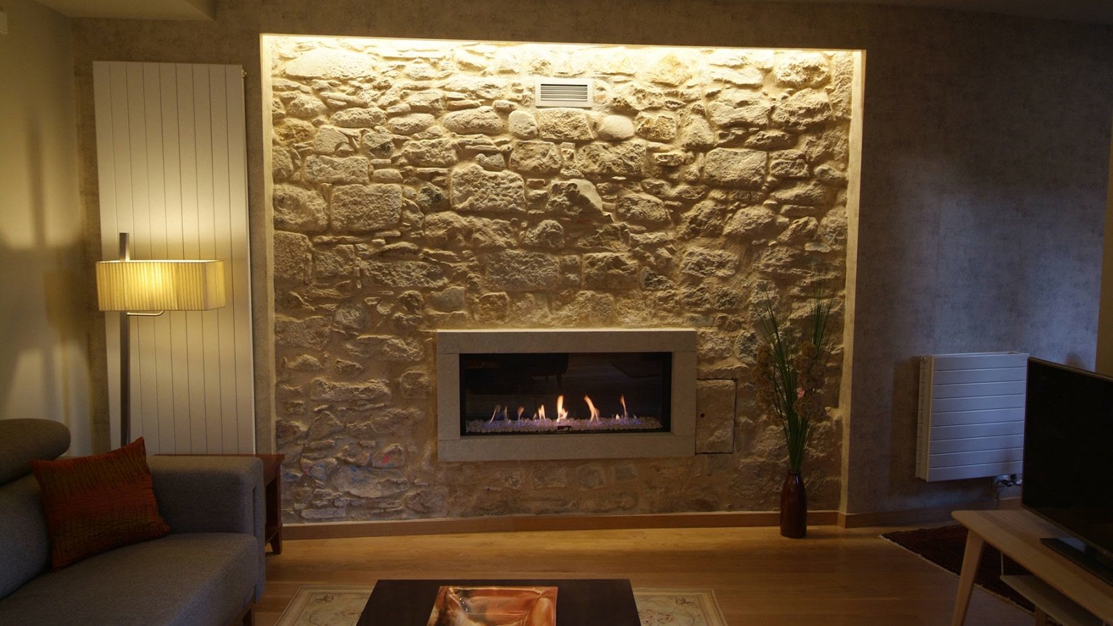 Stone fireplace in the living room at Barri Vell