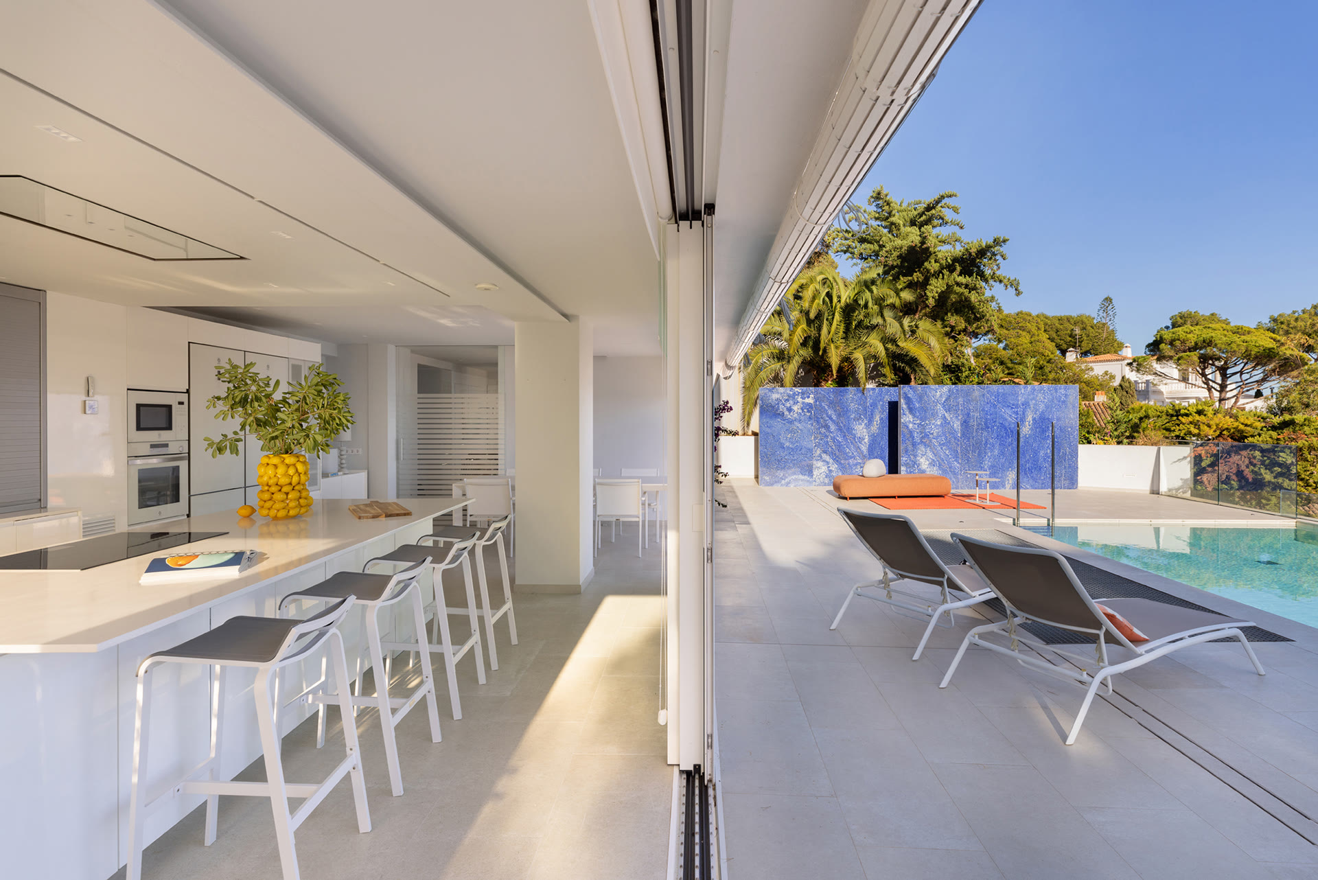 Covered dining terrace beside the pool at Tamariu