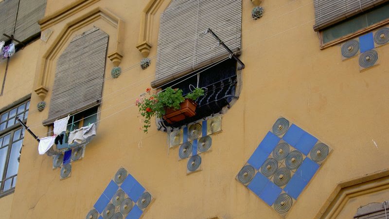Painted tiles on a building facade at Barri Vell