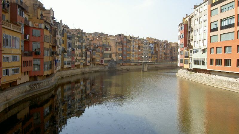 River lined with colorful buildings at Barri Vell