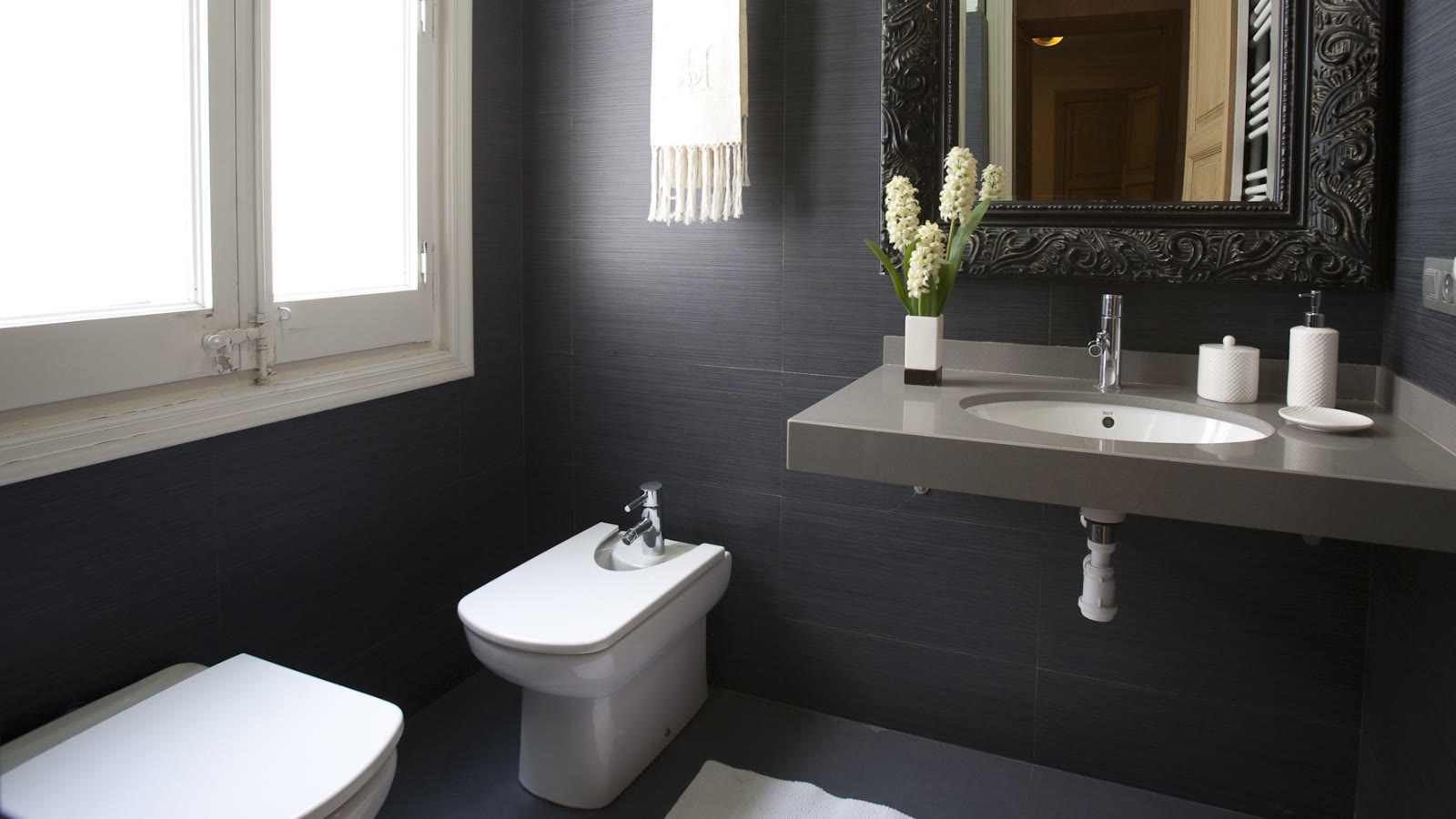 Bathroom with dark vanity at Via Laietana
